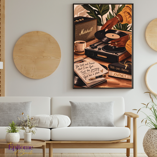 A framed retro-style wall art print hangs above a white sofa in a modern living room. The artwork depicts hands turning a record on a turntable with a Marshall speaker, coffee cup, notebook, and books, in warm brown, beige, and orange tones.