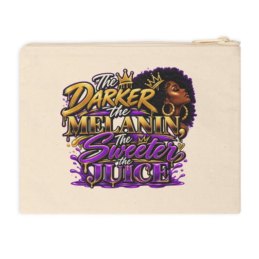 A cream-colored canvas zippered pouch featuring a colorful graphic print with the text 'The Darker the Melanin, The Sweeter the Juice' in gold and purple lettering, alongside an illustration of a Black woman with an afro.