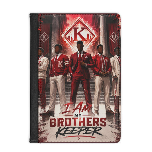 A Passport wallet featuring a graphic print of the Kappa Alpha Psi Men with the text 'I AM MY BROTHERS KEEPER'. The cover has a black spine and a textured red, white, and black design.