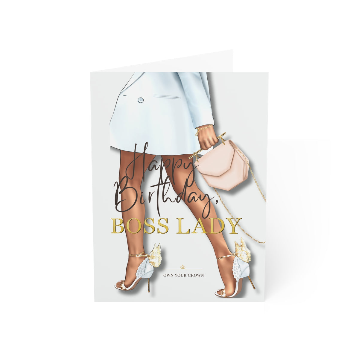 A folded greeting card standing upright on a white background. The card features an illustration of a woman's legs wearing a light blue blazer, beige tights, and high heels, holding a blush pink handbag.