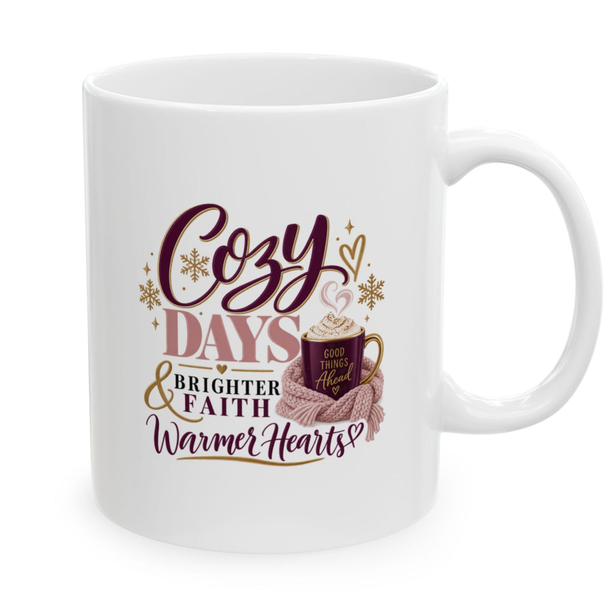 A white ceramic coffee mug with a cozy holiday graphic that reads 'Cozy DAYS & BRIGHTER FAITH Warmer Hearts!'. The design features dark purple text, gold glittery accents, and an illustration of a hot cocoa cup wrapped in a pink scarf.