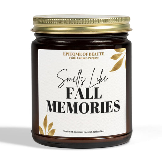 A dark amber glass jar candle with a gold metal lid and a white label that reads 'Smells Like FALL MEMORIES' with small gold leaf illustrations. The brand name 'EPITOME OF BEAUTE' is visible at the top of the label.
