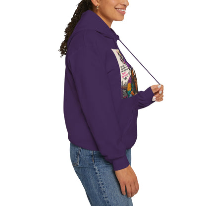 A woman wearing a purple cropped hoodie with a colorful graphic print on the front, paired with blue jeans, shown from a side profile against a white background.