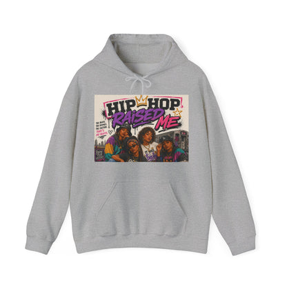 A light gray heather pullover hoodie featuring a large graphic print on the chest with the text 'HIP HOP RAISED ME' and an illustration of four people, shown against a plain white background.